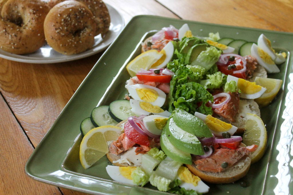 Bagels piled with leftover salmon, cream cheese, avocado, capers, and hard boiled eggs.