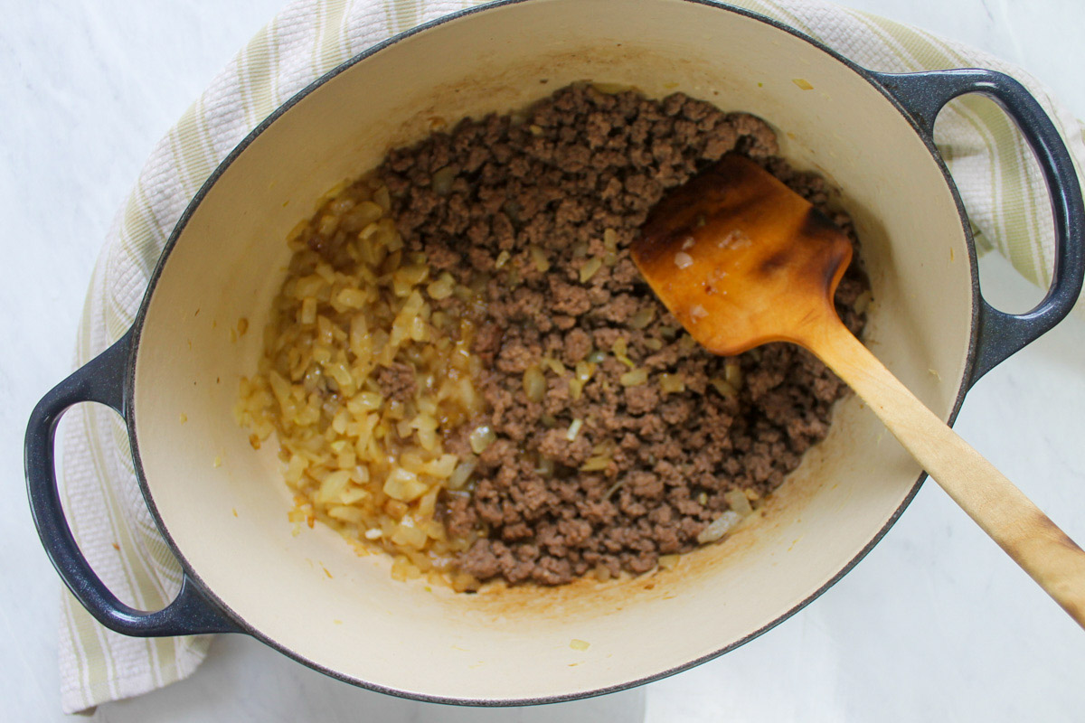 A pot of browning ground beef and onions.