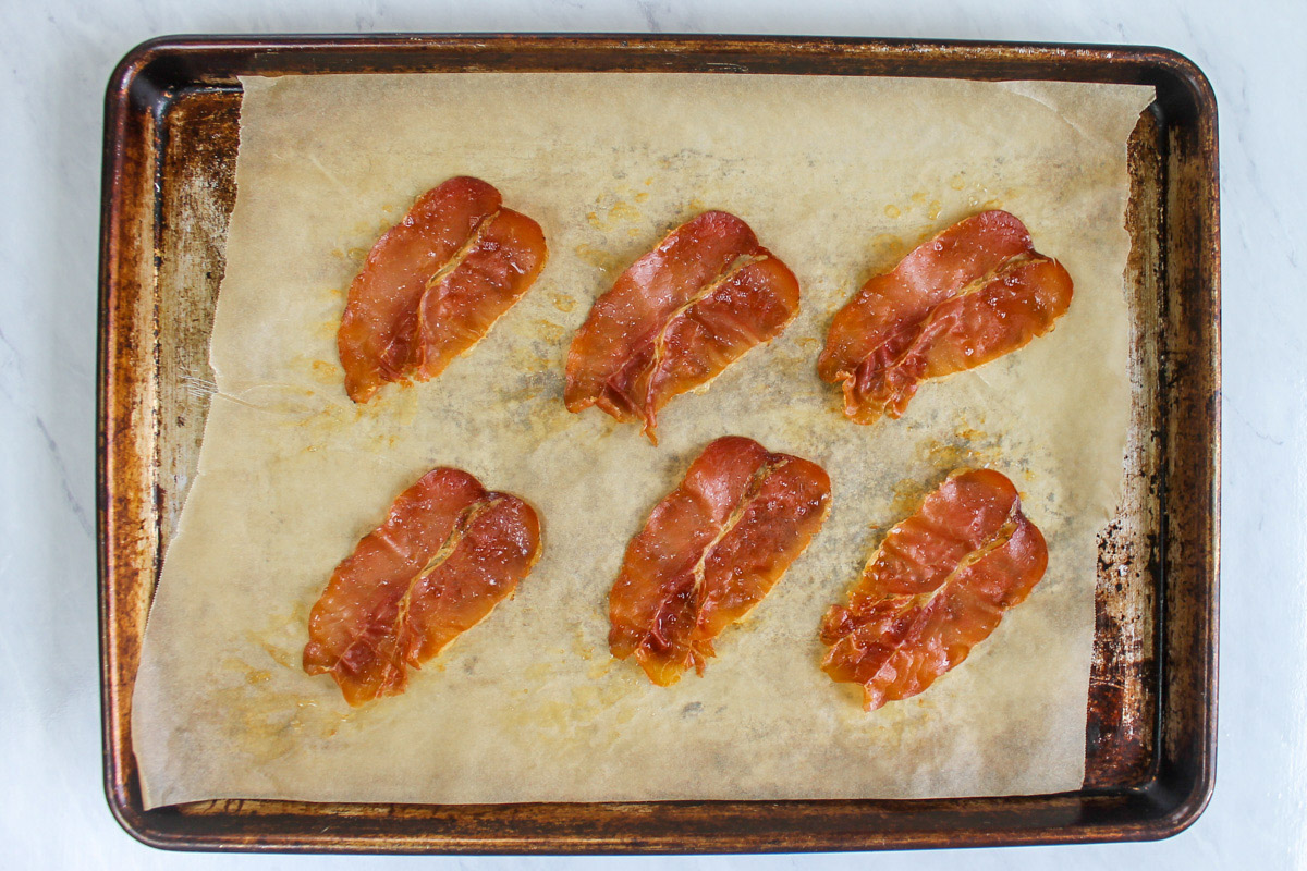 A sheet pan with cooked crispy prosciutto.