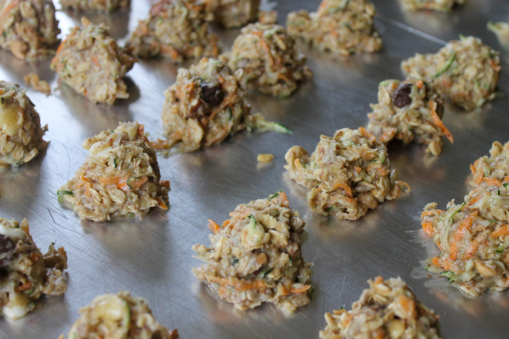 Raw zucchini cookies on cookie sheet pan ready to bake.