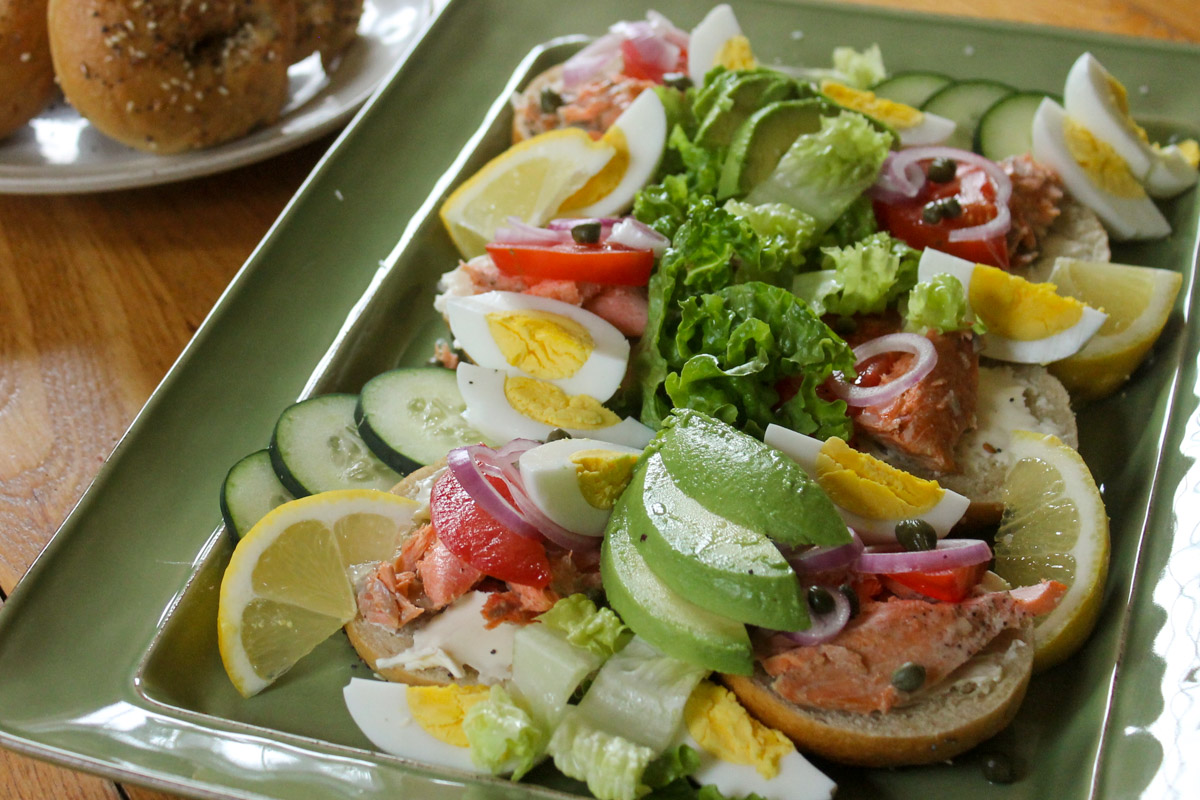 Bagels piled with leftover salmon, cream cheese, avocado, capers, and hard boiled eggs.