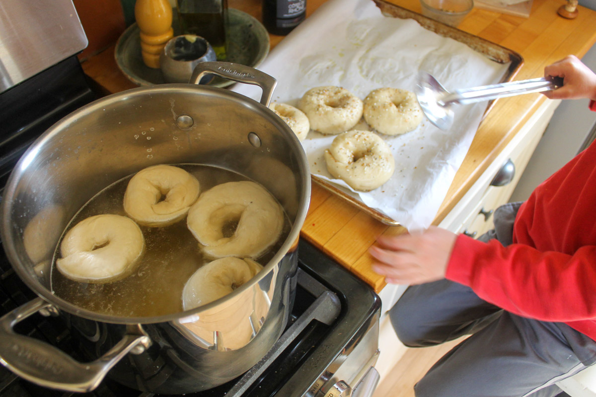 Child cooking homemade bagels.