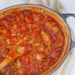 Large Pot of Marinara Sauce with peppers, onions, fennel and Sausage links.