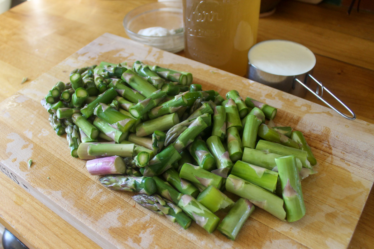 Chopped fresh asparagus on a cutting board.