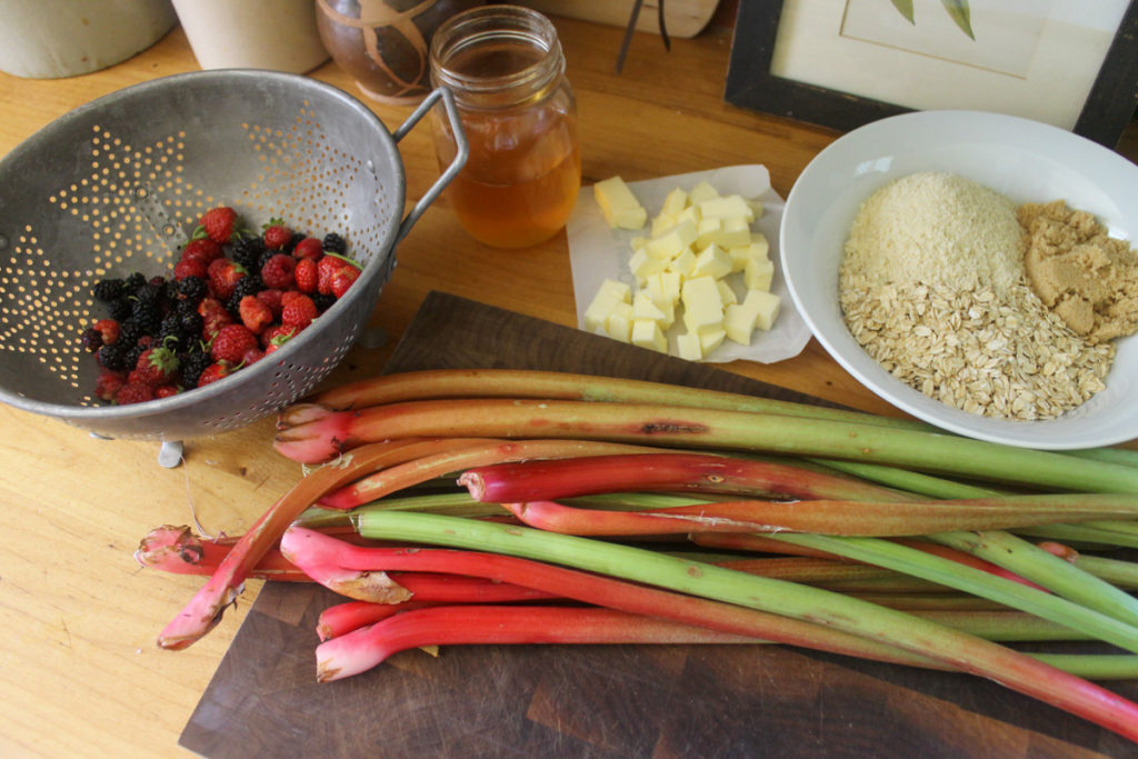 Healthy rhubarb crisp ingredients on a cutting board.