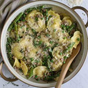 Creamy Asparagus Ravioli with Sausage and Peas.