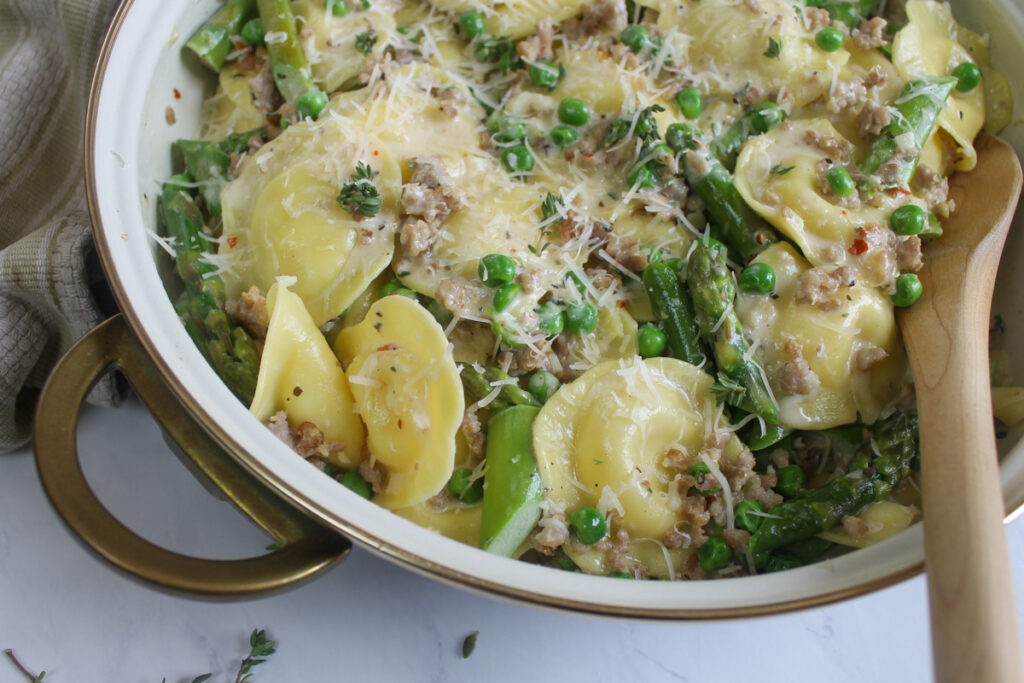 Asparagus and peas with ravioli cream sauce.