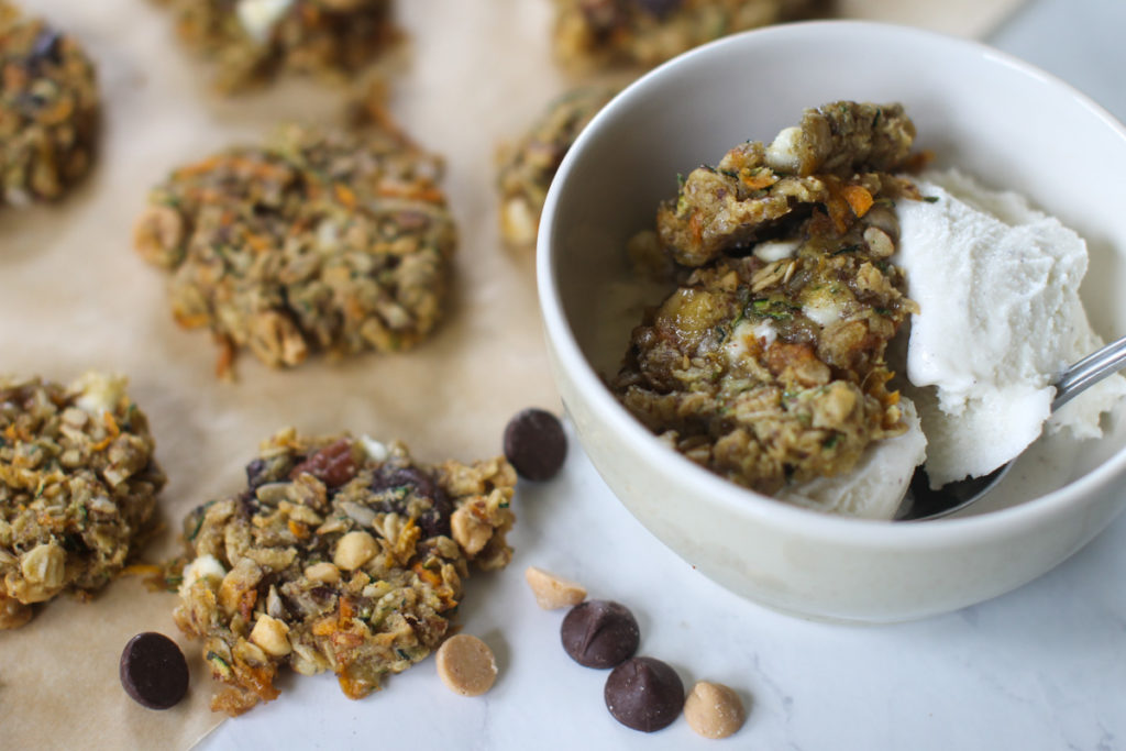 A bowl of vanilla ice cream with zucchini banana cookies and chocolate chips.