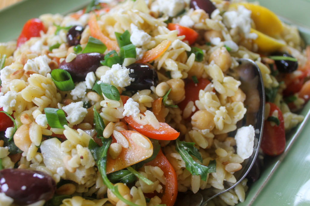 Orzo lemon salad with veggies and feta cheese.