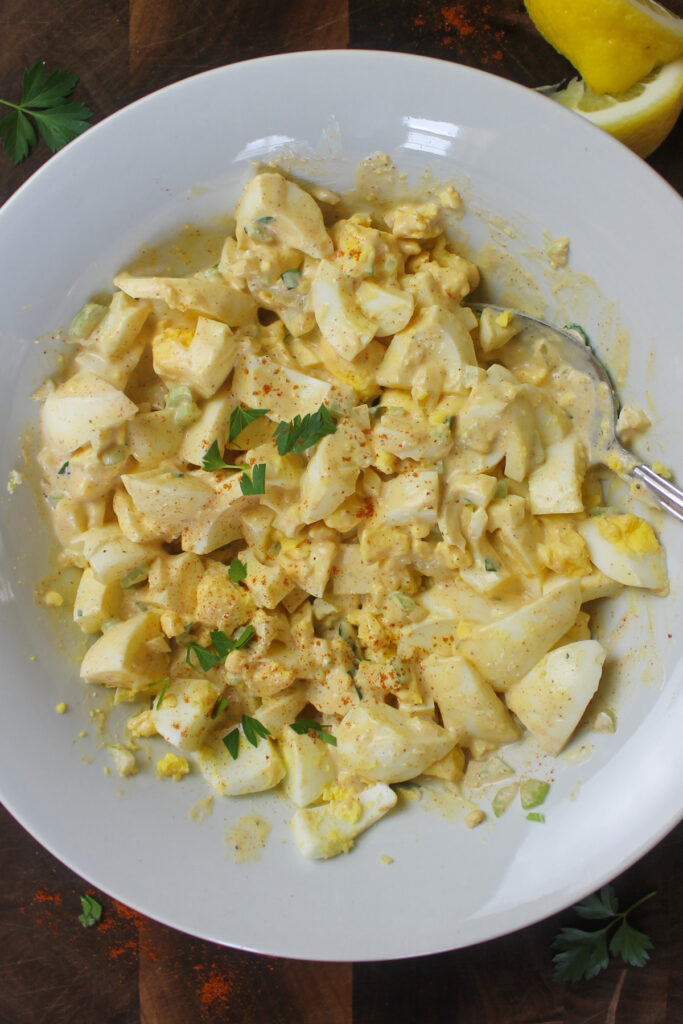 Bowl of egg salad mixed with the dressing.