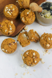 An overhead picture of the tops of banana carrot muffins with a butter dish.