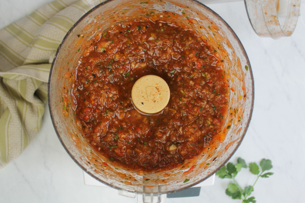 The processed salsa in the bowl of the food processor.