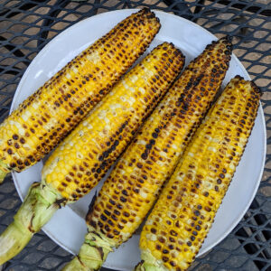 A plate of charred corn on the cob from the grill.