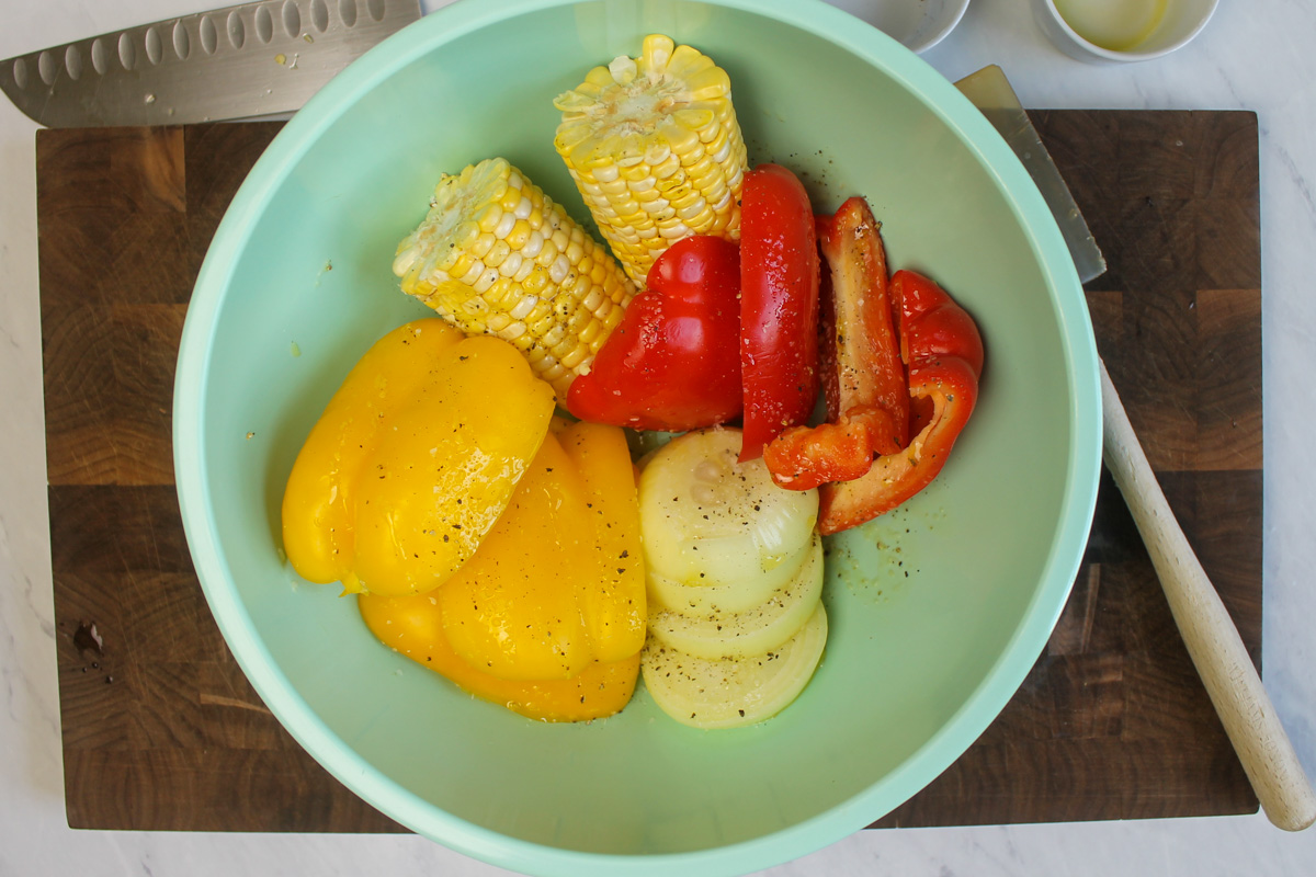 Veggies prepped in a bowl ready to grill.