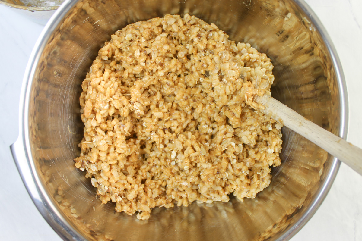A bowl of rice krispies treats being mixed.