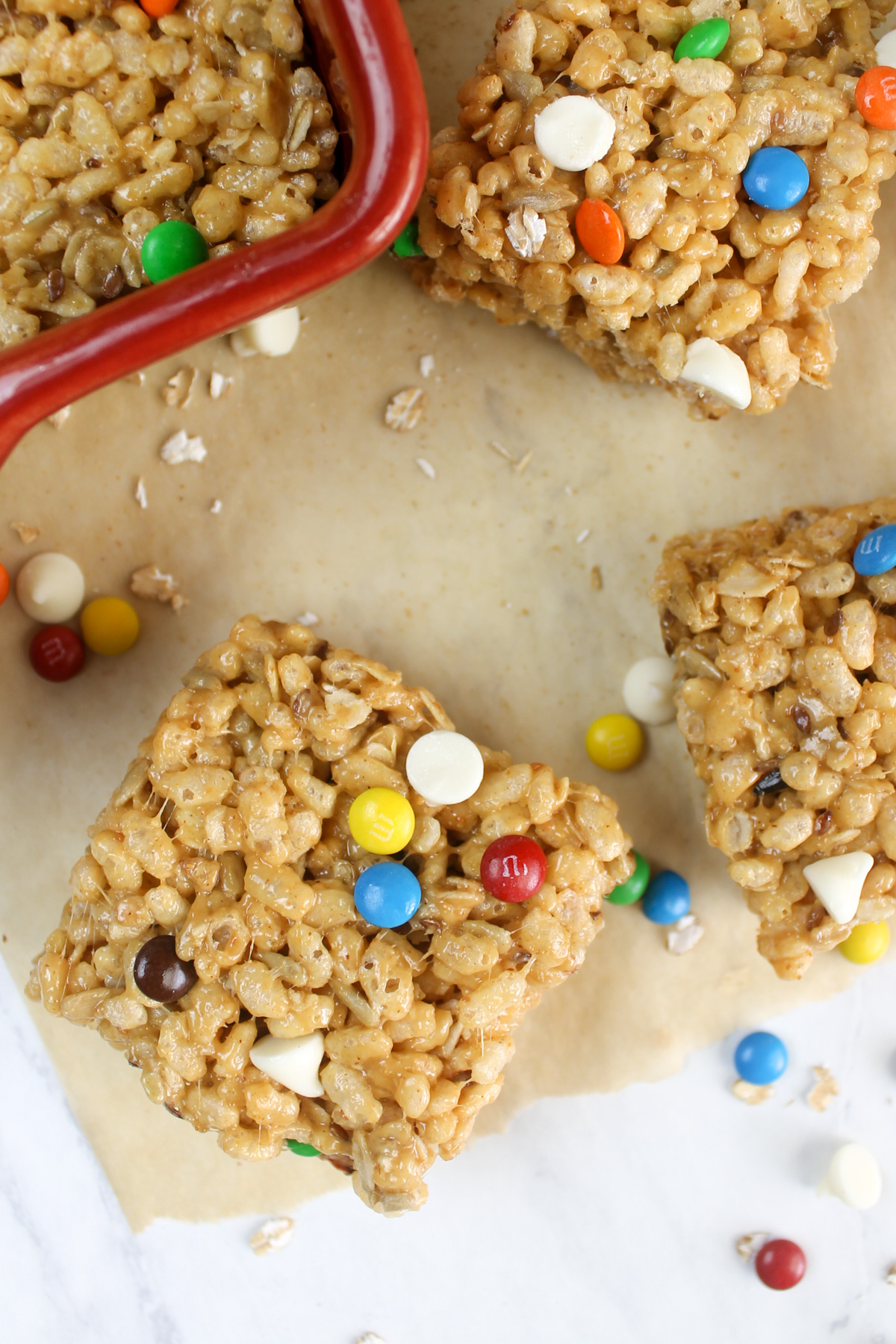 Rice krispie protein bars cut into squares with M&M's.