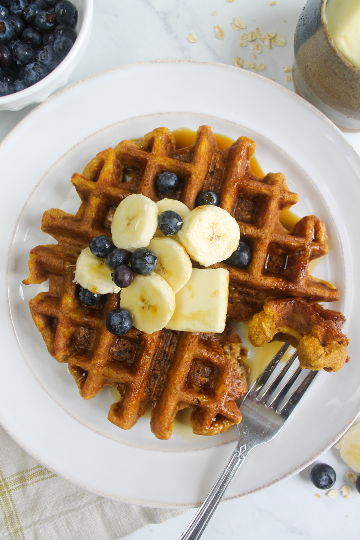 Pumpkin banana protein waffles with maple syrup.