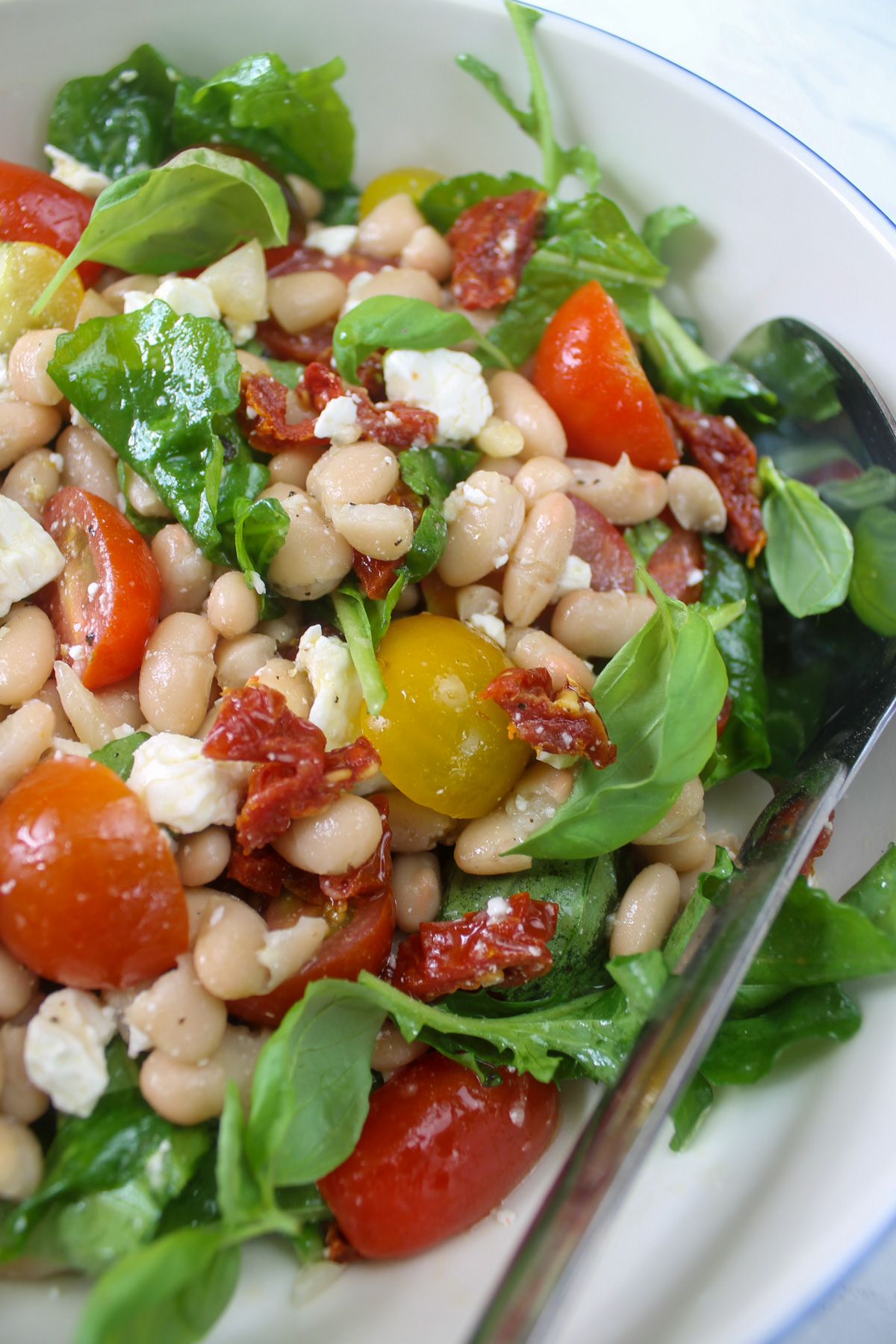 A close up of white bean tomato feta salad.