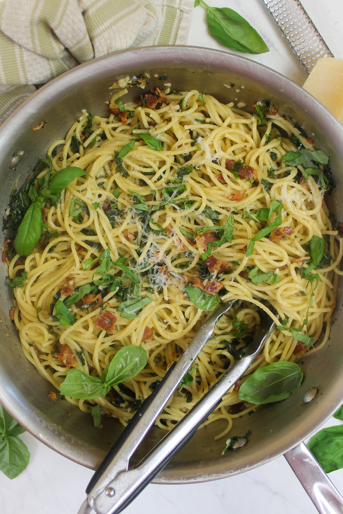 The finished Bacon Kale Spaghetti with basil and Parmesan cheese.