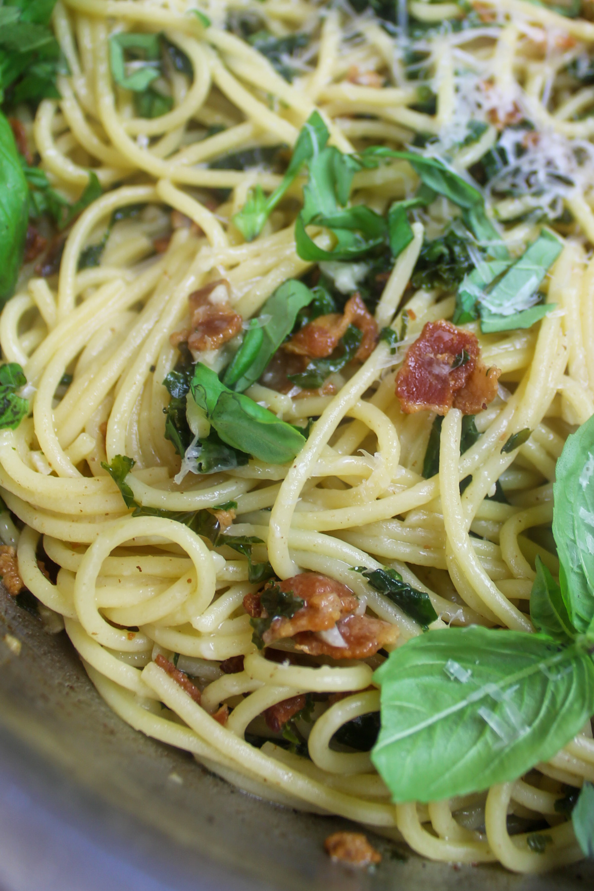 Close up of the silky bacon kale pasta sauce coating the spaghetti.