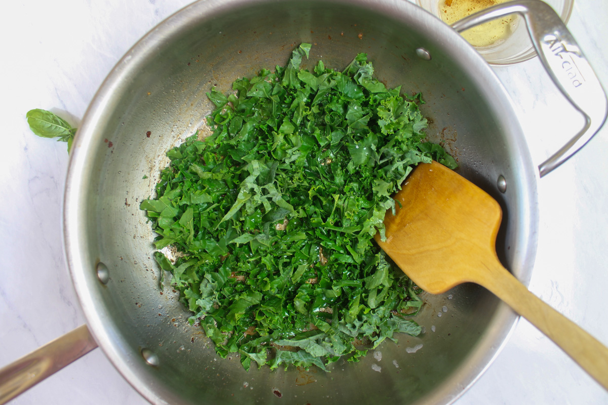 The fresh chopped kale sauteing in the remaining bacon fat.