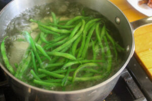 Garden green beans cooking in boiling water.
