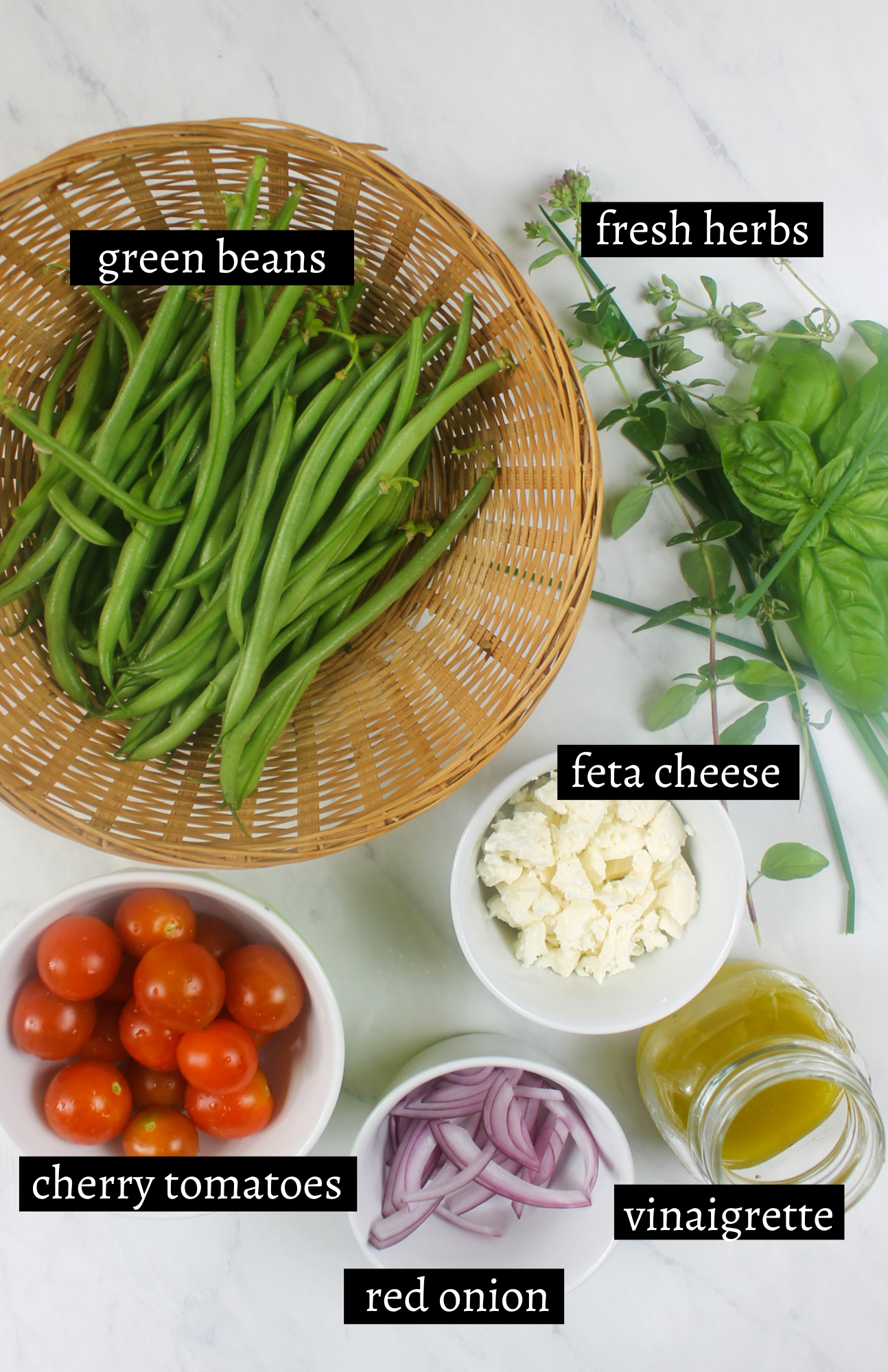 Labeled ingredients for green bean salad with tomato and feta.