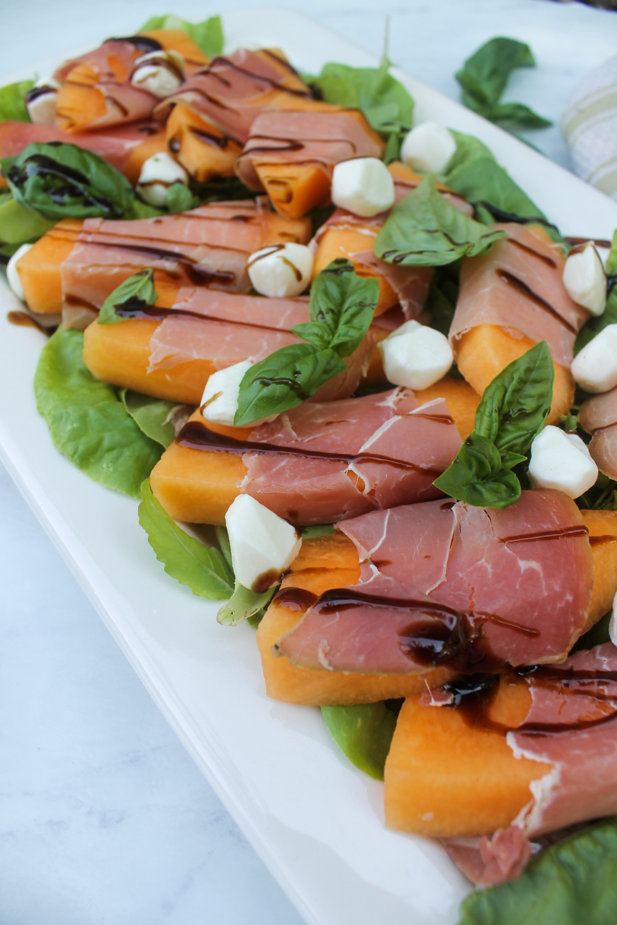 Cantaloupe prosciutto salad with mozzarella pearls.