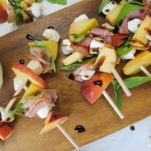 Peach mozzarella skewers with balsamic drizzle.