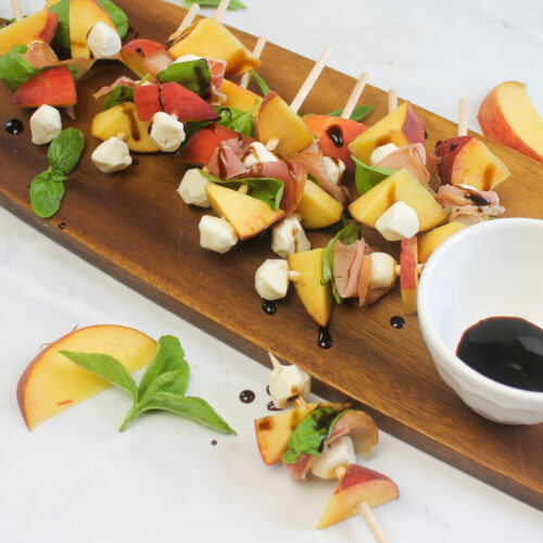 Peach mozzarella skewers with balsamic drizzle.
