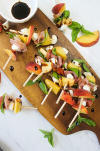 Peach skewers drizzled with balsamic glaze.
