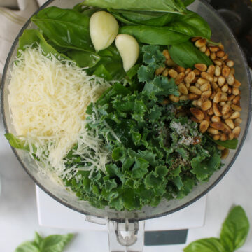 Pesto ingredients in the food processor ready to puree.