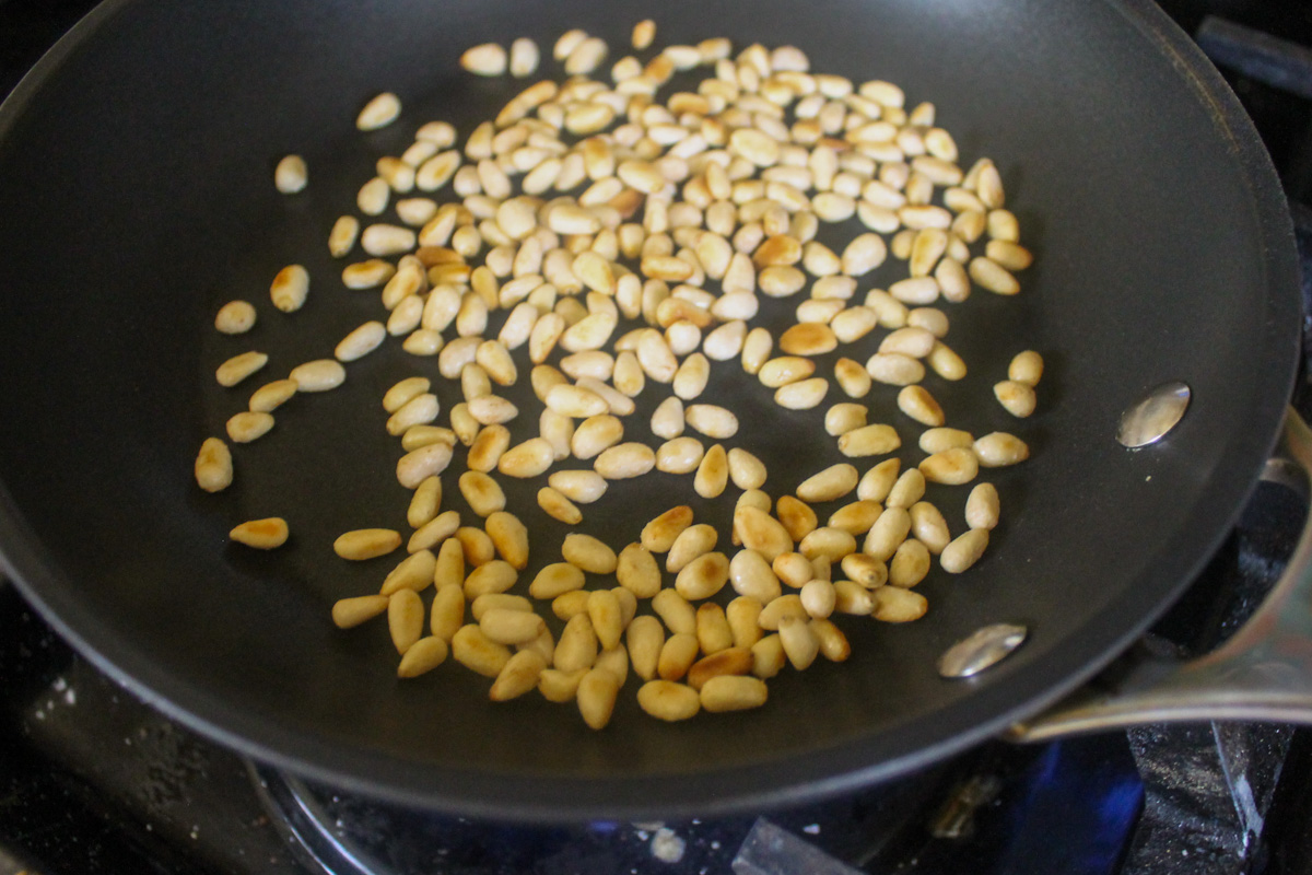 Toasting pine nuts in a dry skillet.