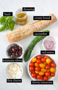 Labeled ingredients for panzanella bread salad with cherry tomatoes.
