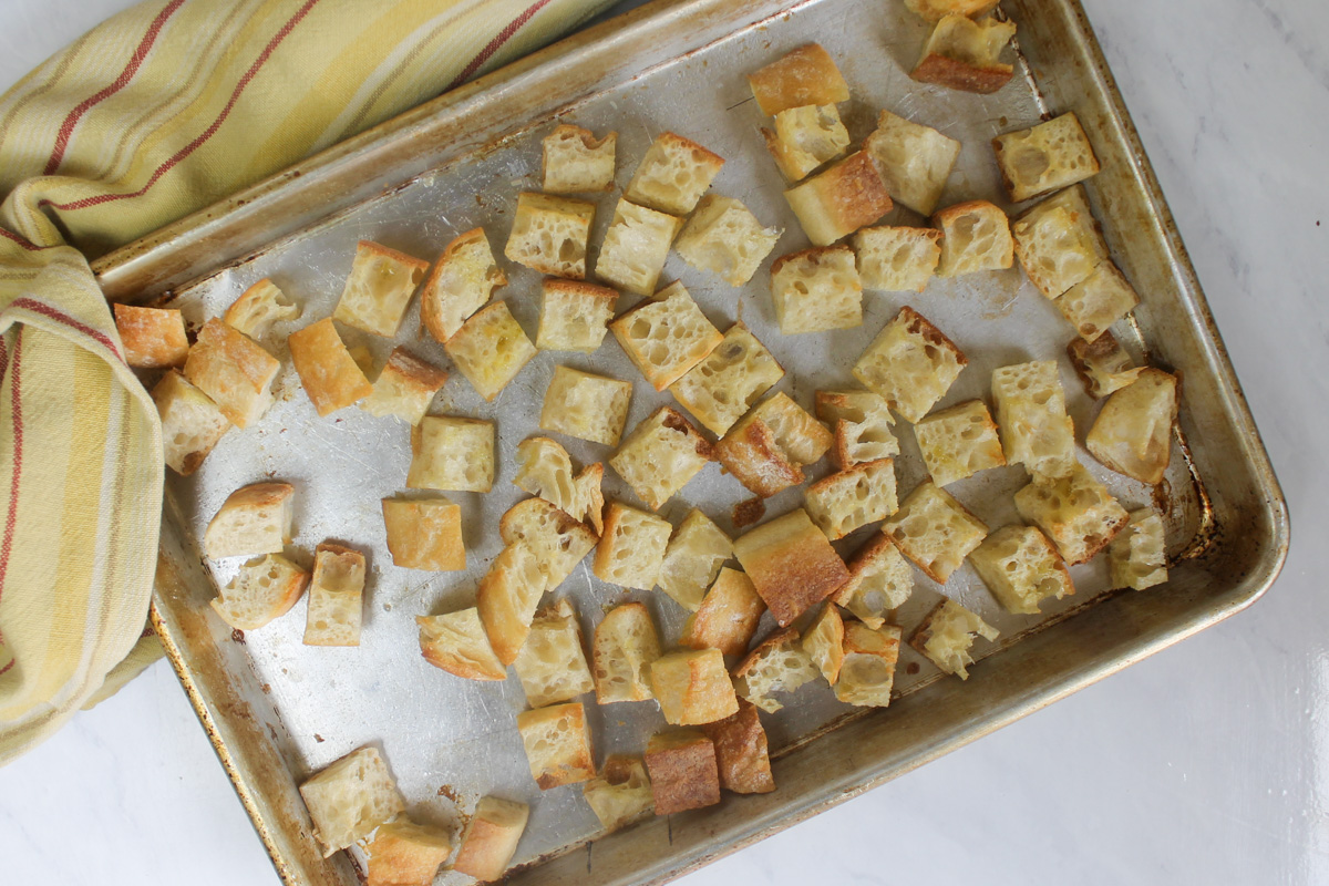 A sheet pan of toasted bread cubes for panzanella salad.