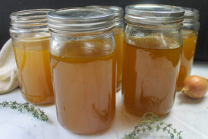 Five quarts of homemade chicken stock from bones and vegetable scraps.