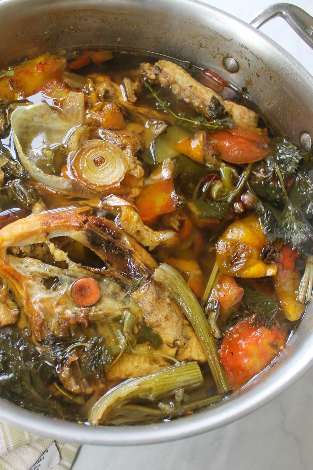 A soup pot of chicken stock ready to be strained.