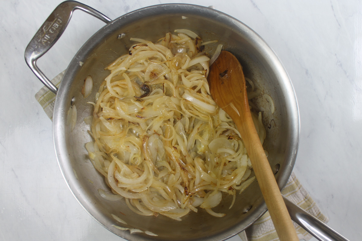 Half way through caramelizing onions in a skillet.