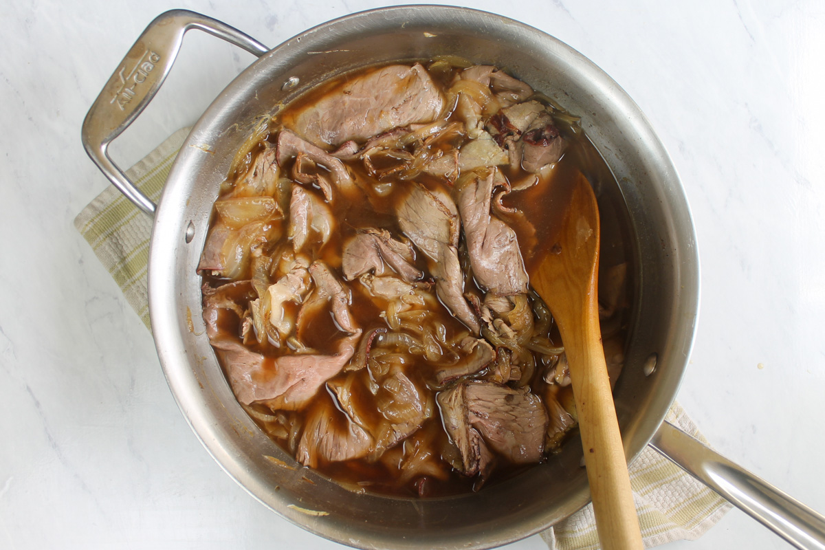 Roast beef deli meat added to the stock and onions to absorb the liquid.