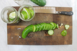 Slicing cucumbers on a cutting board.