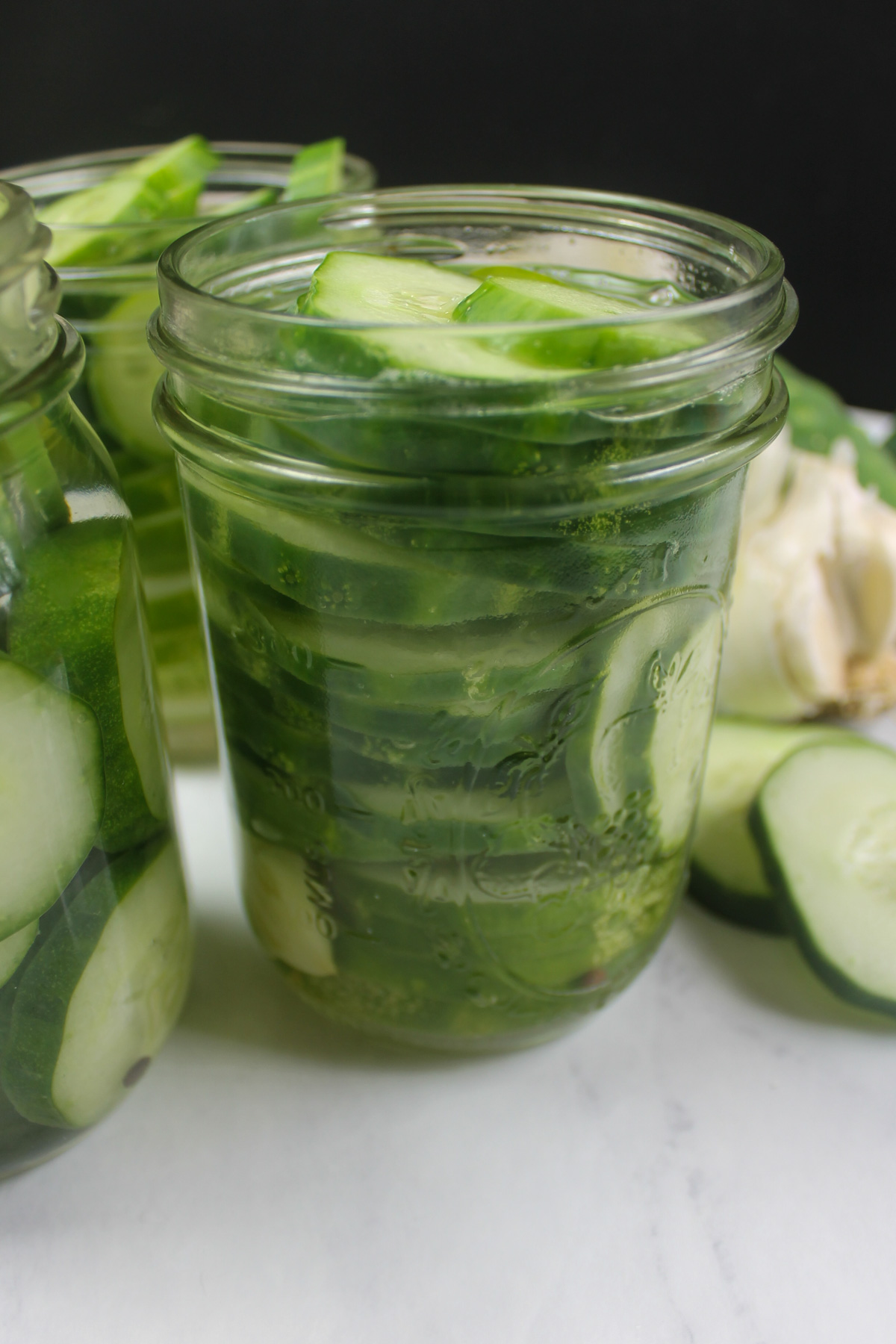 Old fashioned refrigerator pickles with cucumbers and garlic.
