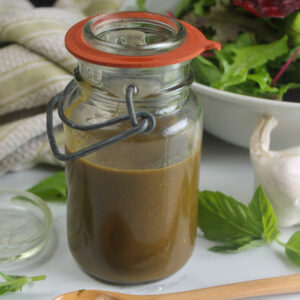 A jar of basil balsamic vinaigrette salad dressing.