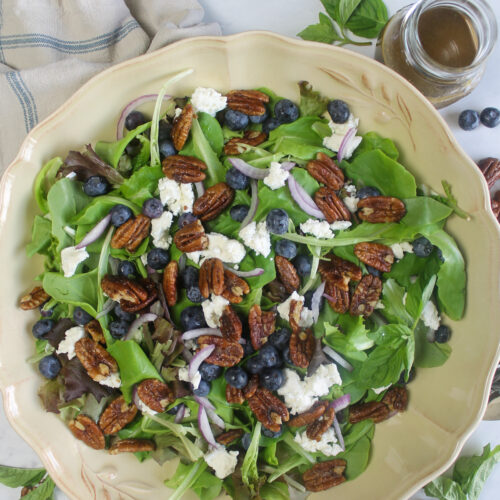 Salad with fresh blueberries, crumbled goat cheese, and candied pecans.