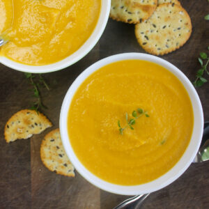 Two white bowls of maple roasted butternut squash soup.