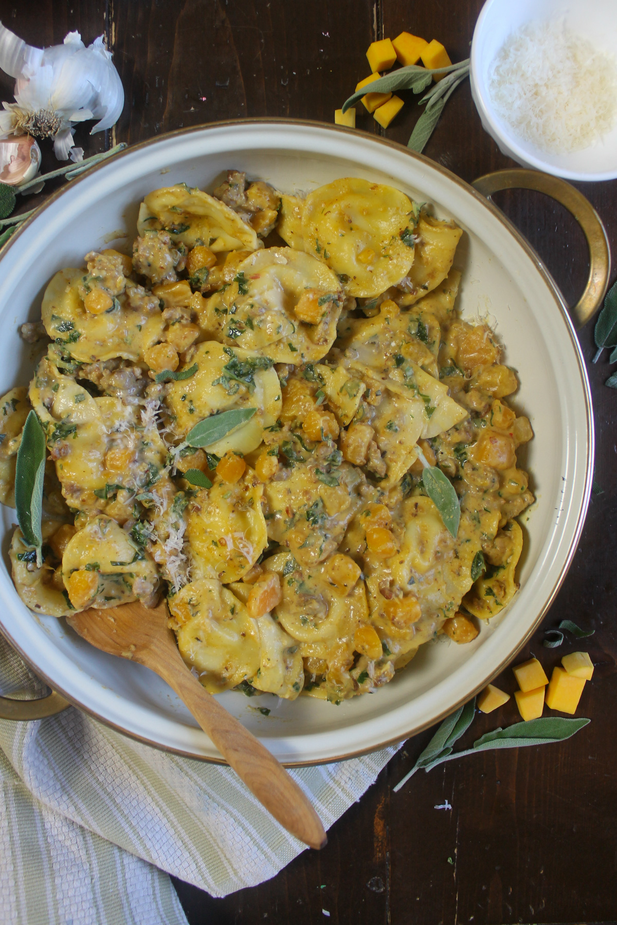 Butternut squash ravioli with cream sauce and sage leaves.