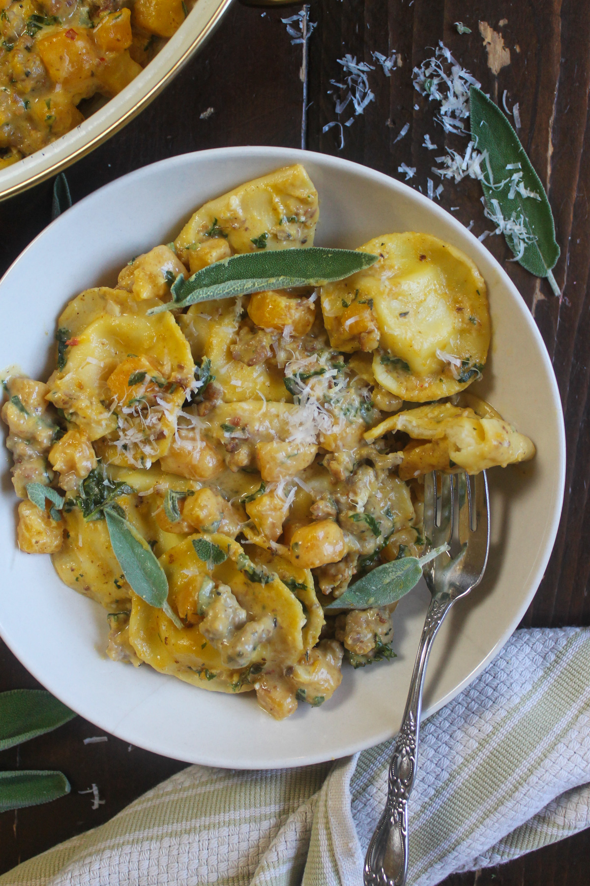 A plate of butternut squash ravioli with sage cream sauce.