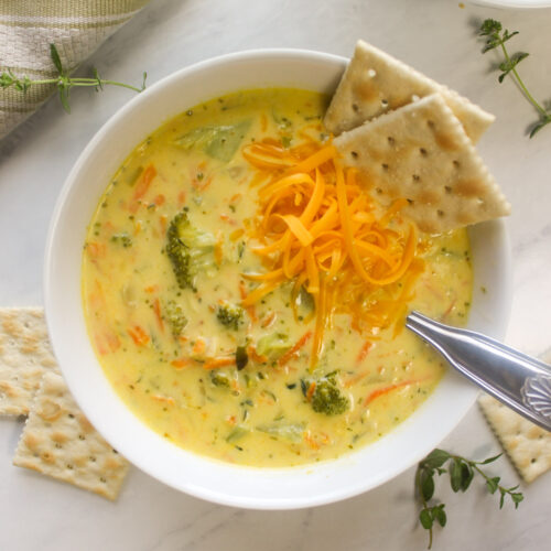 Creamy broccoli and zucchini soup with shredded cheddar cheese.