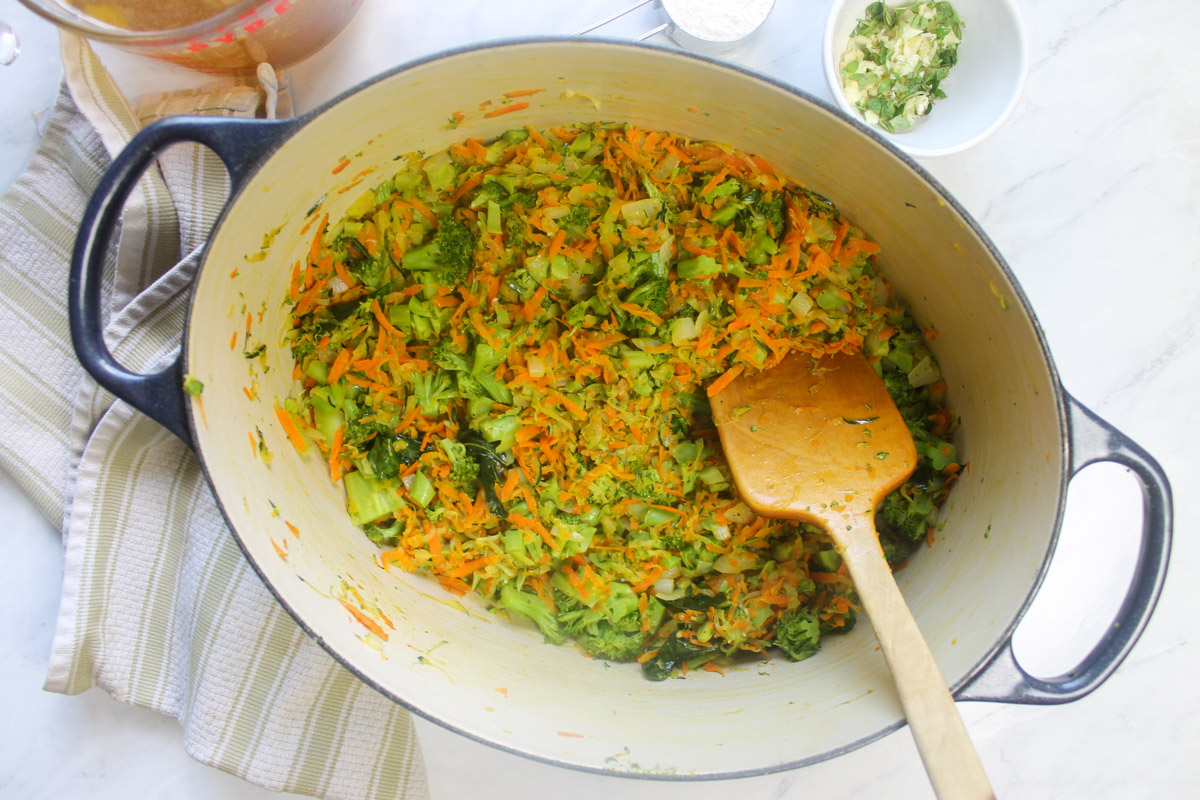 Sauteein onion, carrots, zucchini and broccoli in a soup pot.