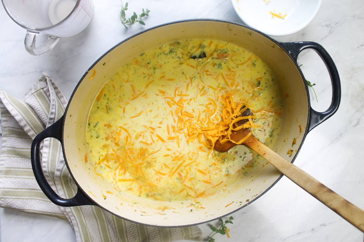 Adding the half and half and cheese to the soup.