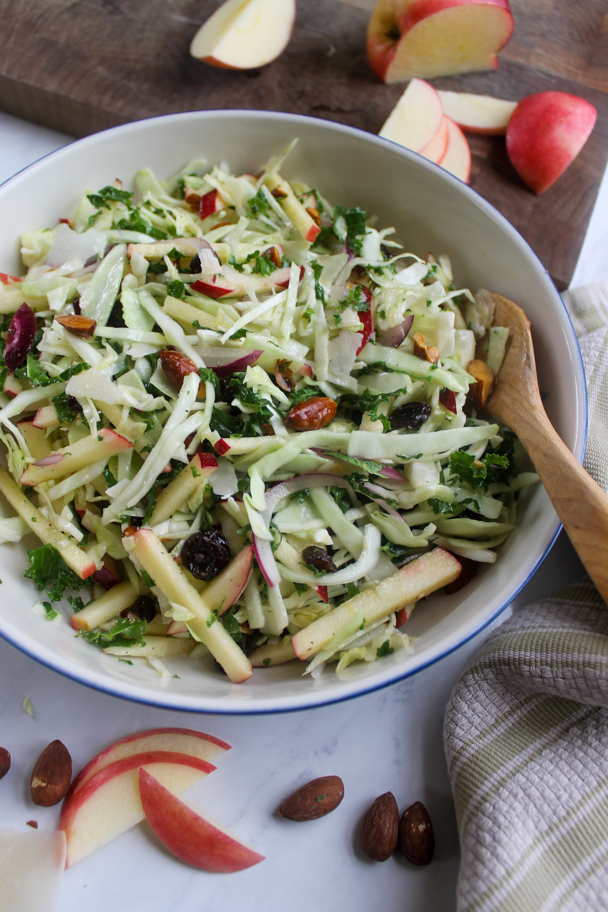 A bowl of kale apple slaw salad with honey apple cider vinaigrette.